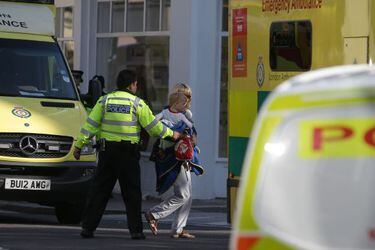 Members of the emergency services work near Parsons Green underground