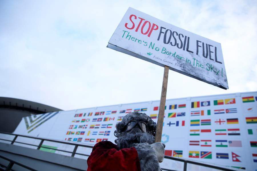 Environmental activist protests against fossil fuel in front of the the venue of the COP24 UN Climate Change Conference 2018 in Katowice