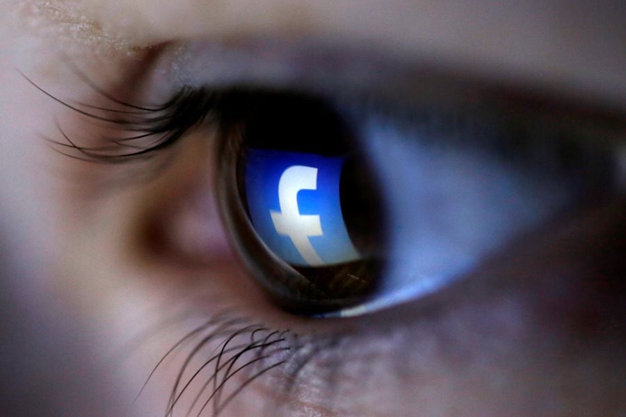 FILE PHOTO: A picture illustration shows a Facebook logo reflected in a person's eye, in Zenica