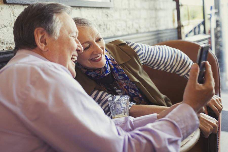 Smiling senior couple taking selfie