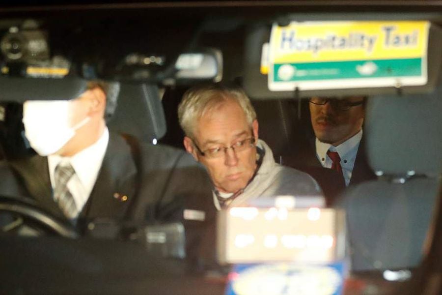 Greg Kelly, the former deputy of ousted Nissan chairman Carlos Ghosn, is seen in the car, as he leaves after being released from a detention centre in Tokyo