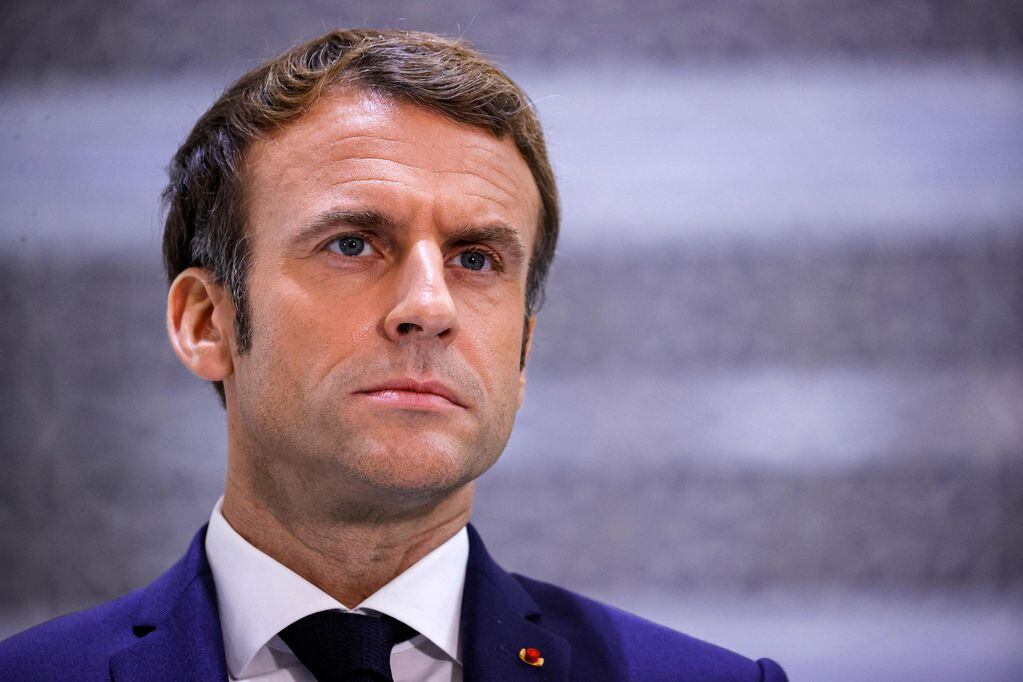 (FILES) This file photo taken on December 4, 2021 shows French President Emmanuel Macron briefing reporters at King Abdulaziz International Airport in Saudi Arabia's Red Sea coastal city of Jeddah. - President Emmanuel Macron on January 5, 2022 warned people in France not yet vaccinated against Covid-19 that he would cause them trouble by limiting access to key aspects of life in the country. (Photo by Thomas SAMSON / AFP)