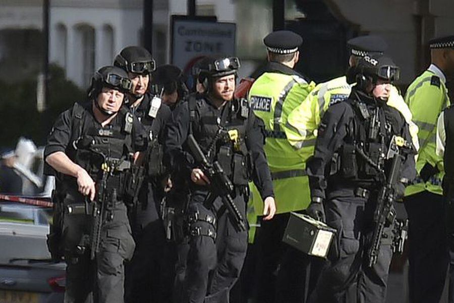 Armed police close to Parsons Green station in west London after an e
