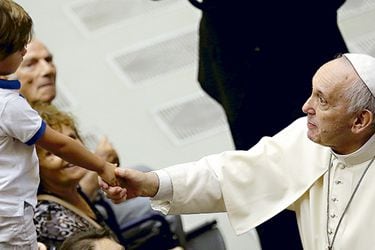 pope-francis-shakes-hands-with-a-boy-during-38835501
