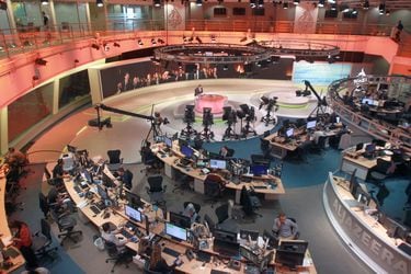 Staff work inside the Al Jazeera Network HQ in Doha