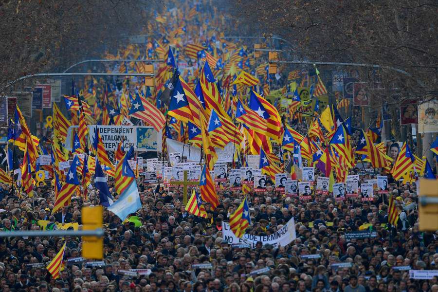 Demonstrators wave Catalan pro-independence Estelada flags during a p
