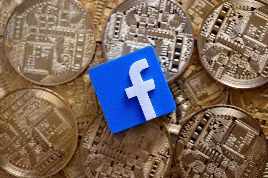 FILE PHOTO: Facebook logo is seen on representations of Bitcoin virtual currency in this illustration picture