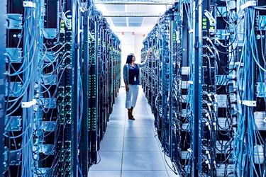 Woman standing in aisle of server room