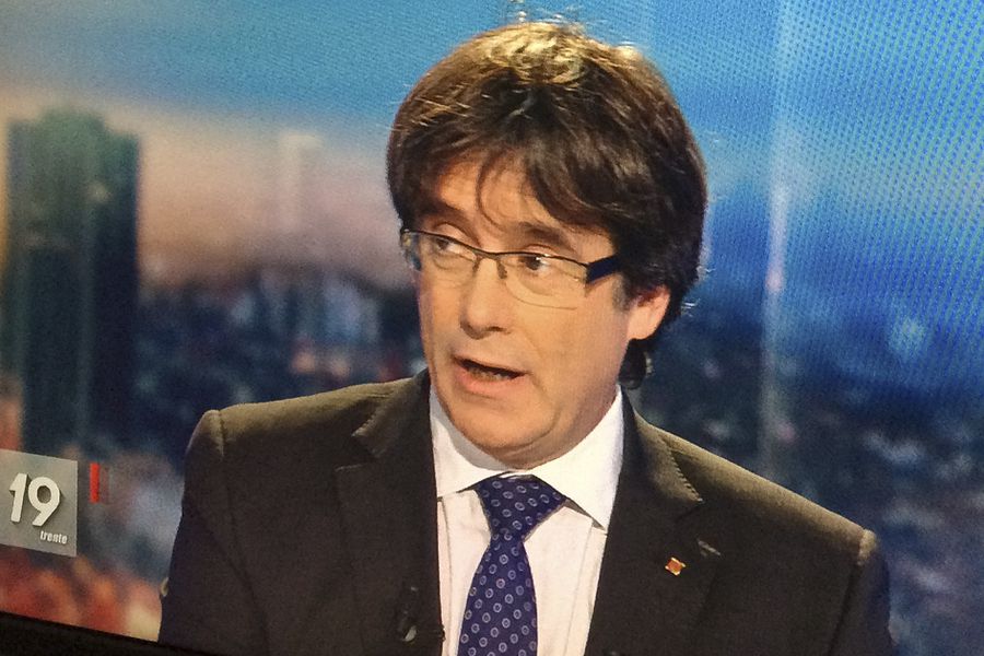 Ousted Catalan President Carles Puigdemont appears on a monitor during a live TV interview in Brussels