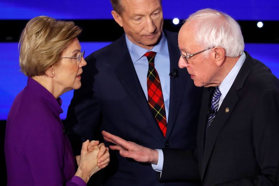 Democratic 2020 U.S. presidential candidates Senator Elizabeth Warren (D-MA) speaks with Senator Bernie Sanders as billionaire activist Tom Steyer listens after the seventh Democratic 2020 presidential debate at Drake University in Des Moines