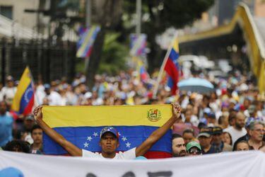 An opposition member holds a Venezuelan national flag during a protes