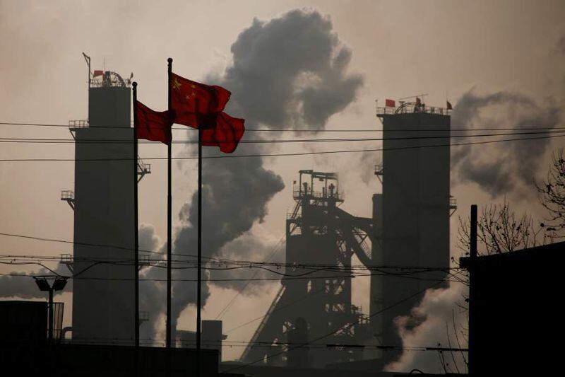 FILE PHOTO - Chinese national flags are flying near a steel factory in Wu'an