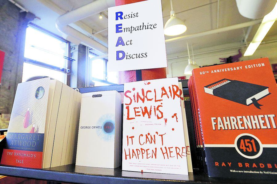 Books are displayed under a sign at the Harvard Book Store