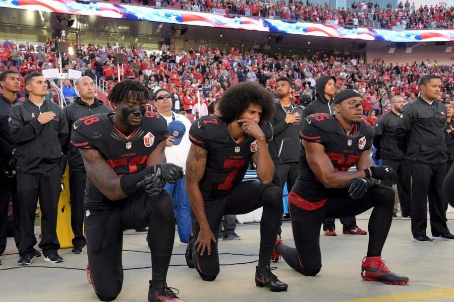 FILE PHOTO: San Francisco 49ers outside linebacker Harold, quarterback Kaepernick and free safety Reid kneel in protest in Santa Clara