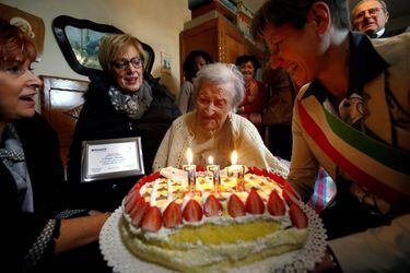 Emma Morano, thought to be the world's oldest person and the last to be born in the 1800s, reacts in front of her 117th birthday cake in Verbania