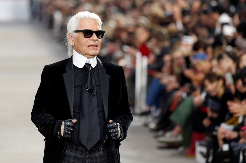 FILE PHOTO -  German designer Karl Lagerfeld appears at the end of his Spring/Summer 2014 women's ready-to-wear fashion show for French fashion house Chanel during Paris fashion week