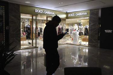A man walks past a outlet of Dolce & Gabbana in Beijing