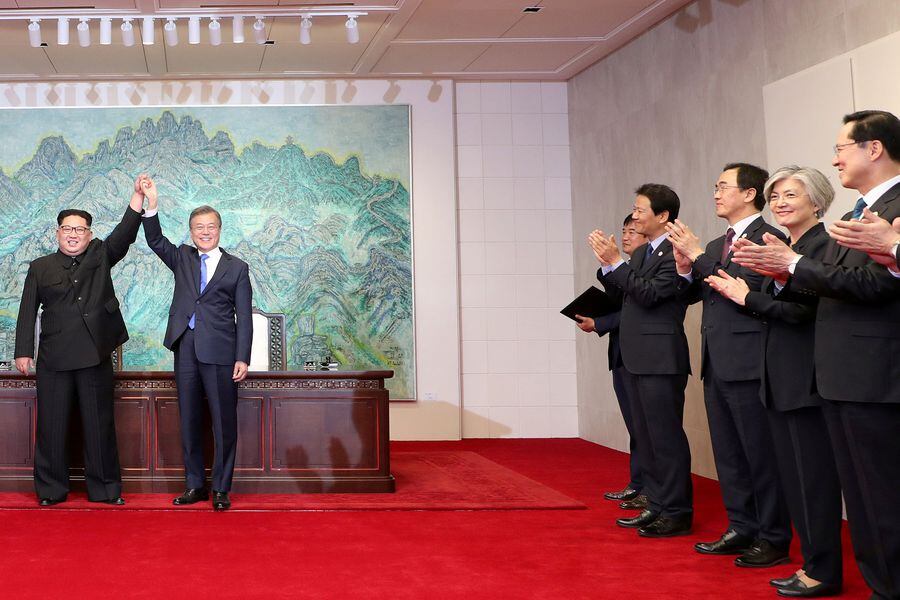 South Korean President Moon Jae-in and North Korean leader Kim Jong Un raise their hands at the truce village of Panmunjom