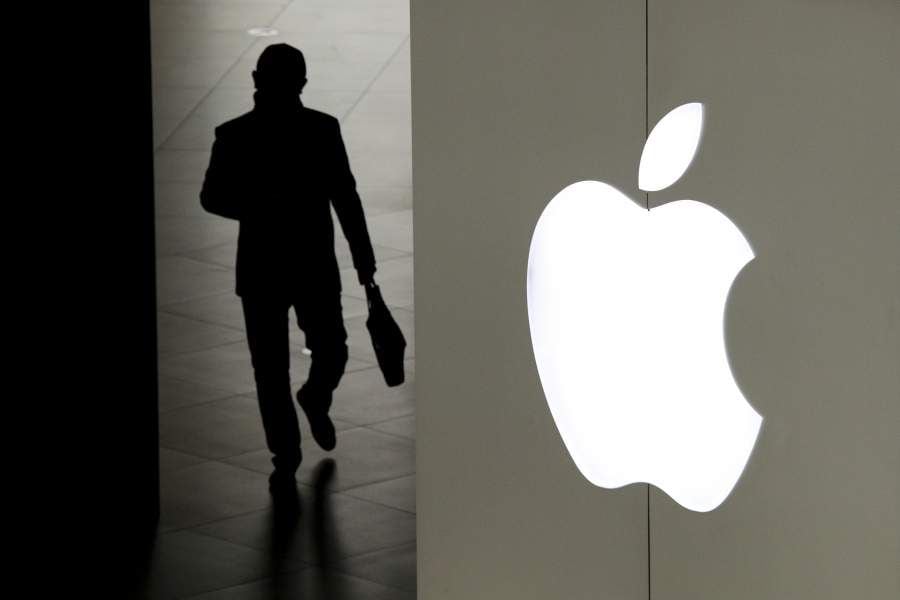 A man leaves an Apple store in Beijing, Thursday, Jan.