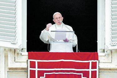 Pope Francis gestures as he speaks during the Angelus prayer in Saint