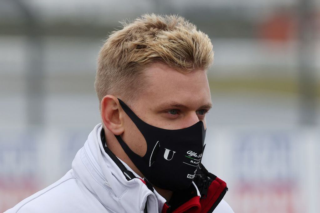 FILE PHOTO: Formula One F1 - Eifel Grand Prix - Nurburgring, Nurburg, Germany - October 8, 2020   Alfa Romeo's Mick Schumacher on the circuit wearing a protective face mask with his team ahead of the Grand Prix   REUTERS/Wolfgang Rattay/File Photo