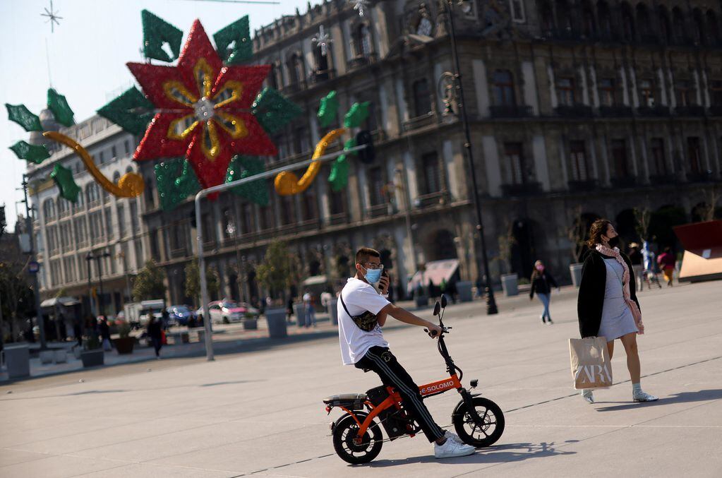 A man rides a moped at Zocalo square as the coronavirus disease (COVID-19) pandemic continues in Mexico City, Mexico January 13, 2022. REUTERS/Edgard Garrido