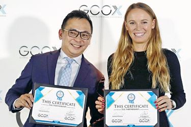 Tennis player Caroline Wozniacki attends a signing ceremony with CEO of GCOX Global Crypto Offering Exchange, Jeffrey Lin, to launch her own cryptocurrency in Singapore