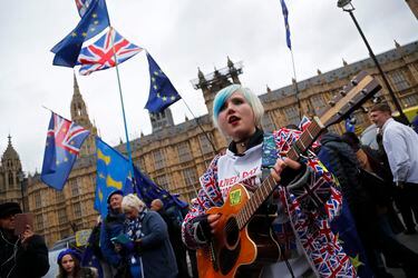 A pro-European demonstrator sings during a protest opposite the House