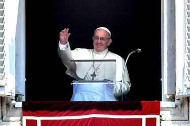 Pope Francis waves to the crowd from the window of the Apostolic Pala