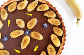 Tarta fina de fondant de chocolate y plátanos acaramelados con crema chantilly de canela.