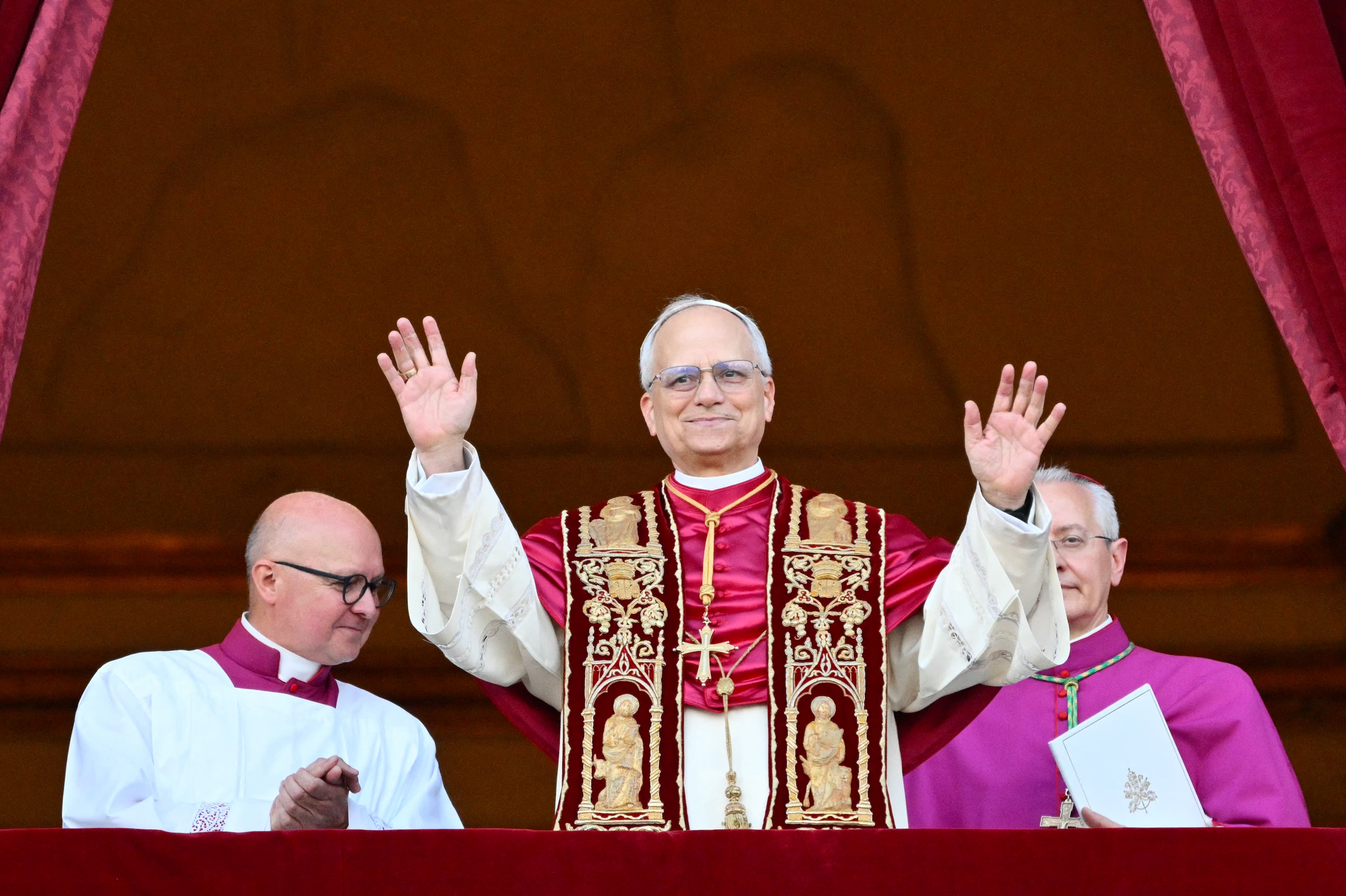 Newly elected Pope Leo XIV, Robert Francis Prevost arrives on the main central loggia balcony of the St Peter's Basilica for the first time, after the cardinals ended the conclave, in The Vatican, on May 8, 2025. Robert Francis Prevost was on Thursday elected the first pope from the United States, the Vatican announced. A moderate who was close to Pope Francis and spent years as a missionary in Peru, he becomes the Catholic Church's 267th pontiff, taking the papal name Leo XIV. (Photo by Alberto PIZZOLI / AFP)