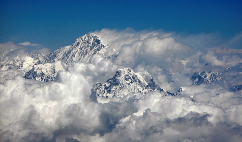 FILE PHOTO: Mount Everest (top), the world's highest peak, is visible in this aerial view
