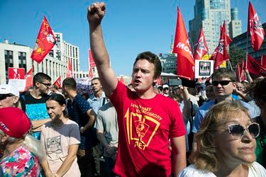 A man gestures during the Communist Party rally protesting retirement