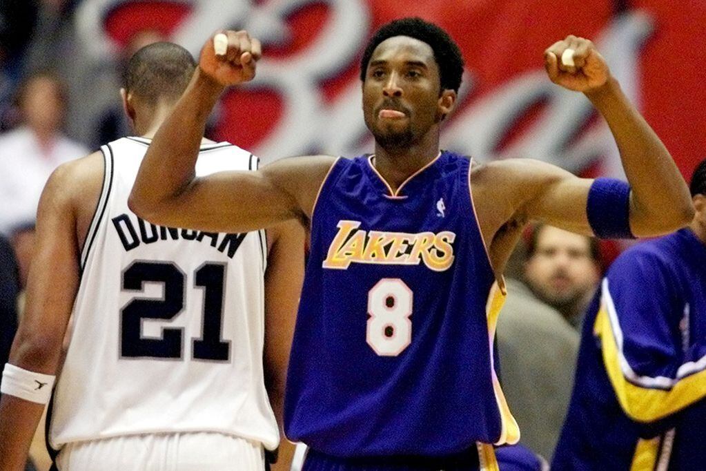 FILE PHOTO: ON THIS DAY -- May 21  May 21, 2001     BASKETBALL - Los Angeles Lakers guard Kobe Bryant celebrates while San Antonio Spurs forward Tim Duncan walks off disconsolately during Game 2 of the Western Conference Finals at the Alamodome in San Antonio.     Duncan's monster 40-point game went in vain as Bryant added 28 points of his own to lead Los Angeles to an 88-81 victory and a 2-0 lead in the series.     The Lakers went on to sweep San Antonio before defeating Philadelphia 76ers 4-1 in the NBA Finals to seal their second straight championship.  REUTERS/Andess Latif/File photo