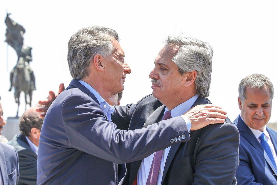 Argentina's outgoing president Mauricio Macri and President-elect Alberto Fernandez embracing during a mass held at Lujan, in Buenos Aires