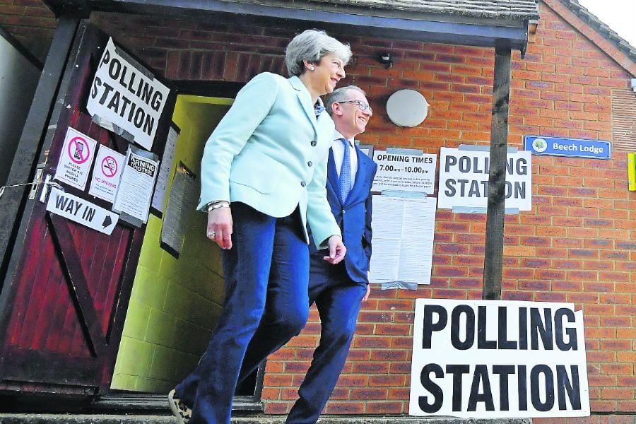Britain's Prime Minister Theresa May and her husband Philip leave after voting in the European (45645121)