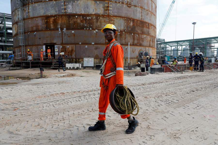 FILE PHOTO: A construction worker walks through the Dangote Oil Refinery under construction in Ibeju Lekki district, on the outskirts of Lagos