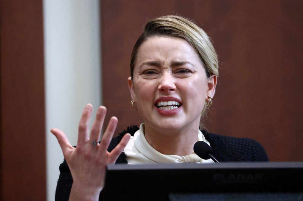 Actor Amber Heard reacts on the stand in the courtroom at Fairfax County Circuit Court during a defamation case against her by ex-husband, actor Johnny Depp, in Fairfax, Virginia, U.S., May 5, 2022. Jim Lo Scalzo/Pool via REUTERS     TPX IMAGES OF THE DAY