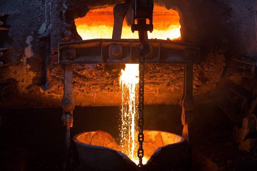 Molten liquid copper is poured from a furnace at a copper refinery