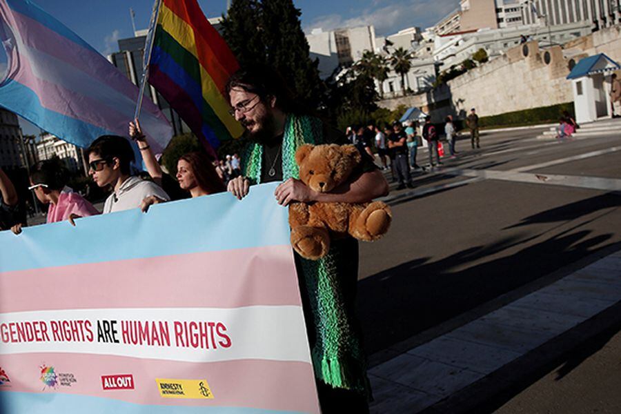 Protesters take part in a demonstration as the Greek Parliament debates bill allowing people to choose legal gender, in Athens