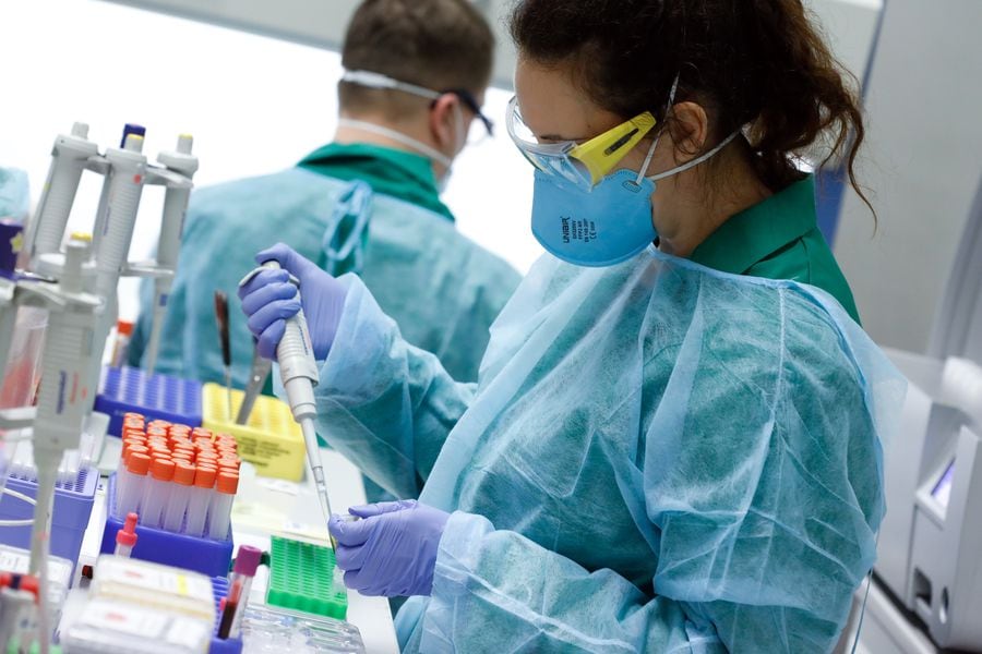 Employees in protective clothing do testings for the corona virus at a laboratory in Berlin, Germany, March 26, 2020, as the spread of the coronavirus disease (COVID-19) continues. REUTERS/Axel Schmidt
