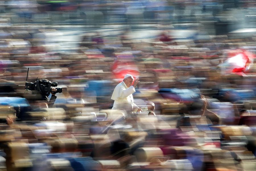Pope Francis waves as he arrives to lead the Wednesday general audience in Saint Peter's square at the Vatican