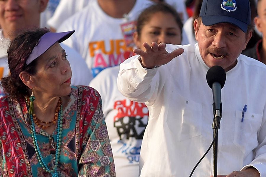 Nicaraguan President Daniel Ortega (R) delivers a speech next to his